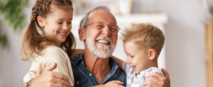 grandfather with his two grandchildren smiling and thinking about trust controversies
