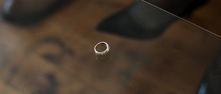 wedding ring sitting on a glass table