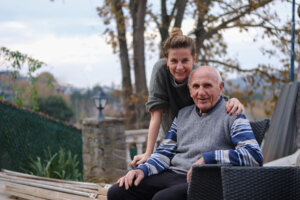 Daughter visiting and lovingly caring for her aging father.