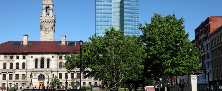 A sunny view of a city center with a building labeled 